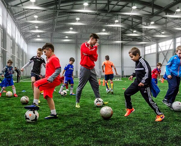 Coach guiding football practice
